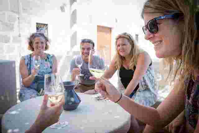 Four travelers enjoying a glass of wine at Saints Hills Winery in Croatia