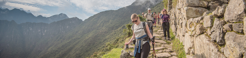 Travellers walking past Machu Picchu on the Inca Trail in Peru
