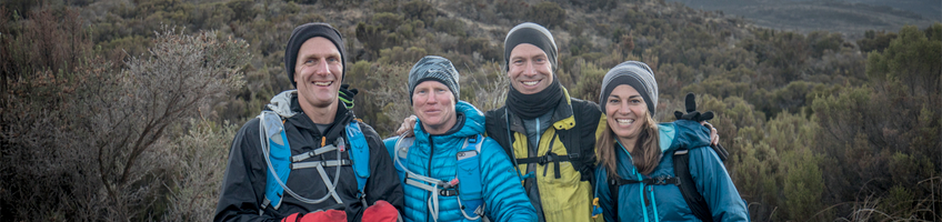A group of travellers smiling at the camera during a Kilimanjaro climb