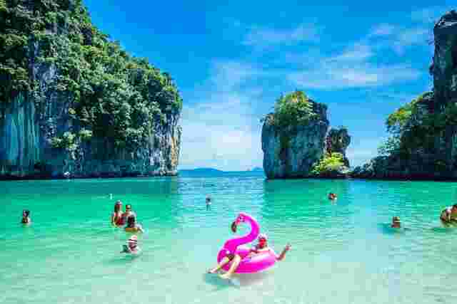 Travellers enjoying the turquoise water of the Hong Islands, Thailand
