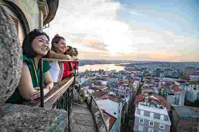 A group of people enjoying the view at the top of the Galata Tower in Istanbul, Turkey