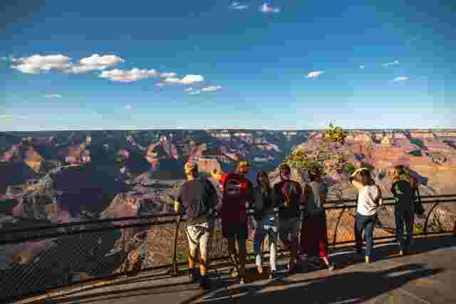 A group of people on an Intrepid tour looking at the Grand Canyon