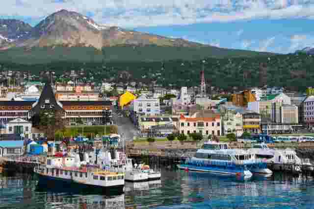 The colourful boats at the port of Ushuaia with the Martial Mountains in the distance.