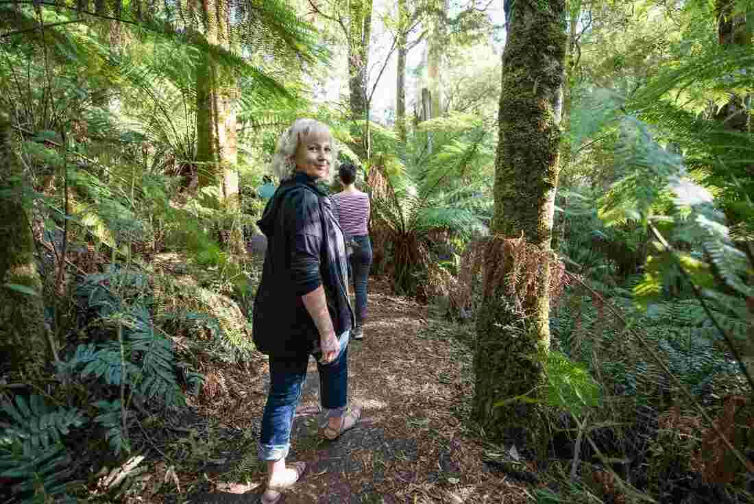 Woman walking on a forest path in Victoria, Australia