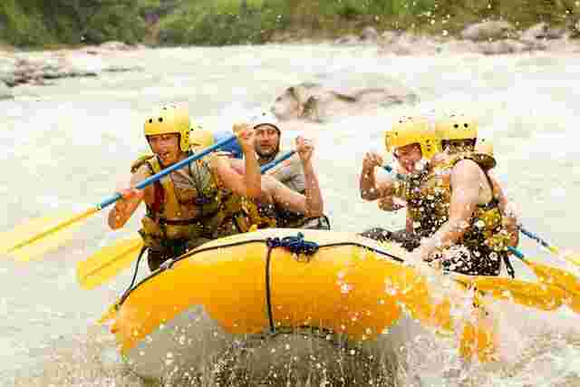 A group of travellers white water rafting in Costa Rica