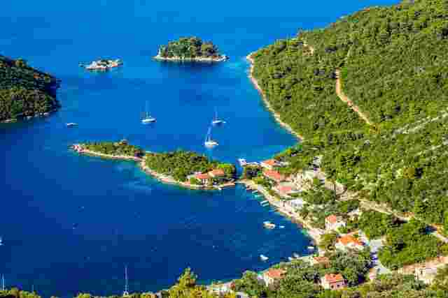 Hilltop view of the lush forests and turquoise water of MIjet, Croatia 