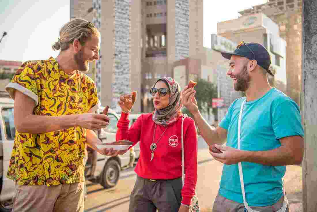 Leader talking to two travellers in Egypt