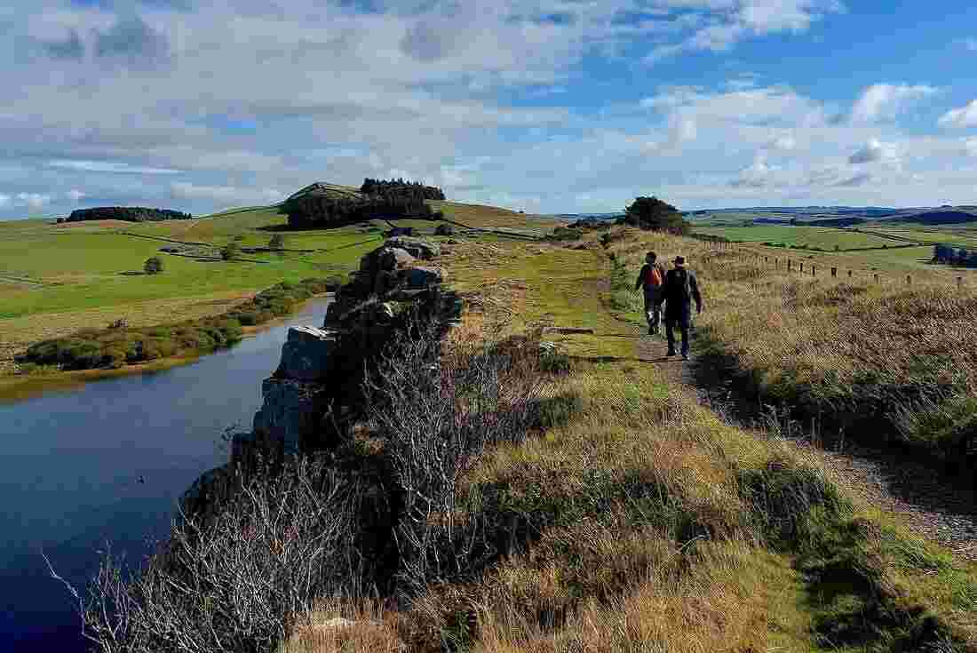 Travellers hiking along the Hadrian Wall in England, United Kingdom