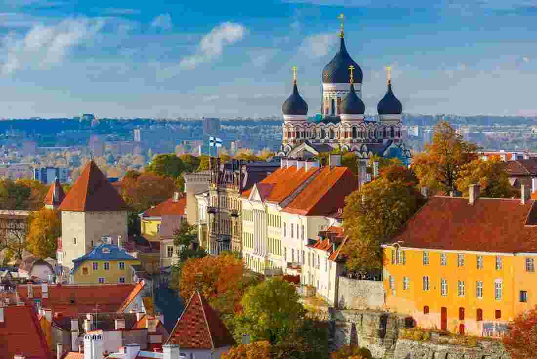 Tallinn, the colorful capital city of Estonia, stands out against a bright, blue sky