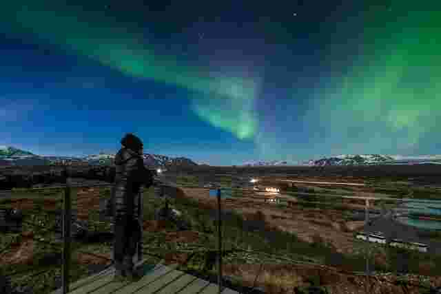 A traveller admiring the northern lights in Iceland