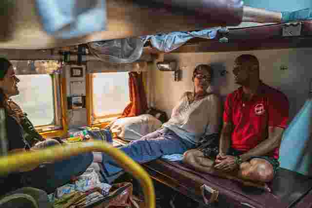 Travellers sitting in a train carriage in India