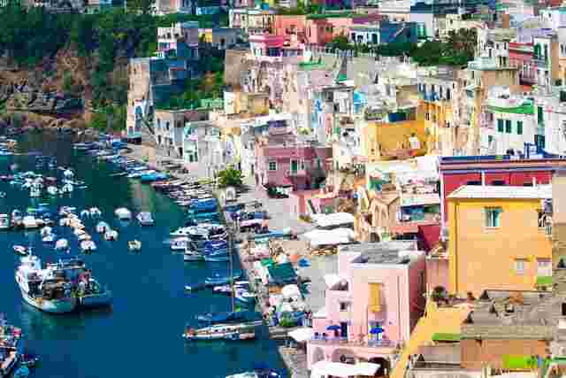 A collection of pastel coloured buildings on the coast of Naples in Italy 