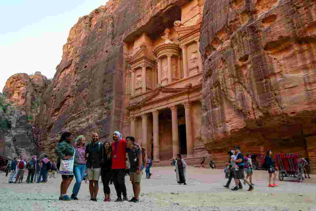 Group of travellers in front of the Treasury, Petra