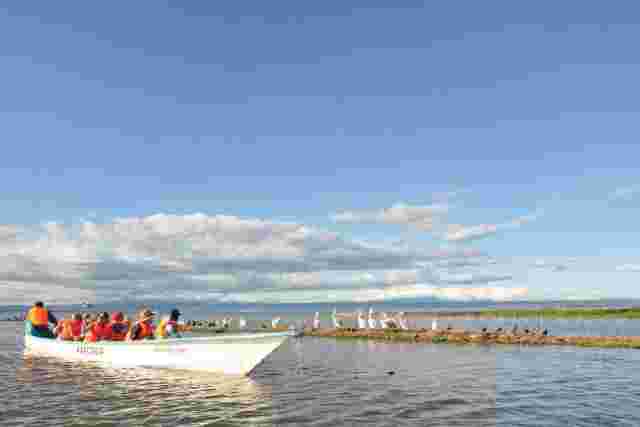 A group of travellers on a boat cruising along Lake Naivasha