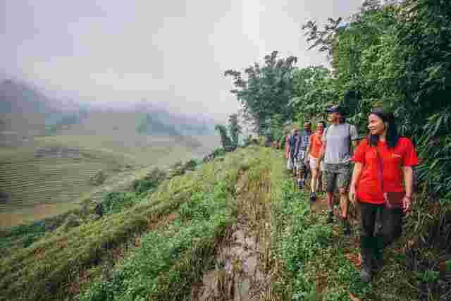 A local leader guiding her group through the Sapa Valley in Vietnam 