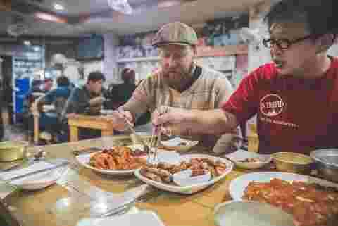 Travellers enjoying fried chicken in South Korea