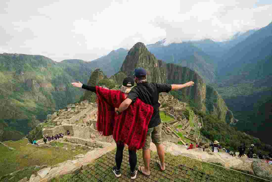 Travellers lookover the view of Machu Picchu