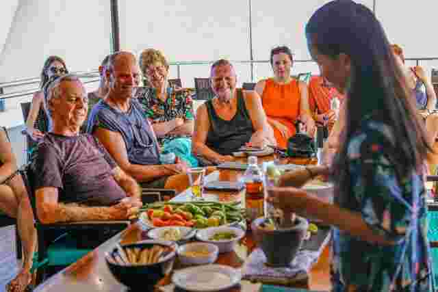 A group of people enjoying a cooking class in Thailand
