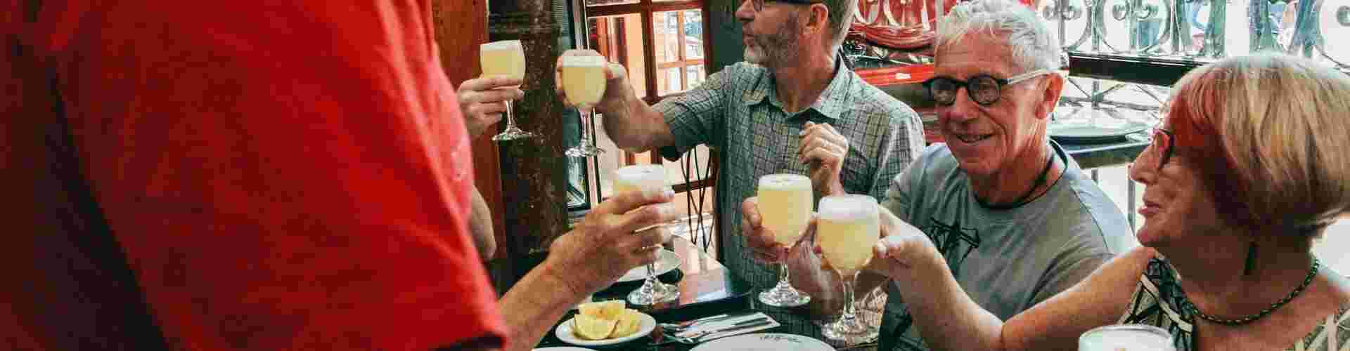 A group of people raising a toast of cheers at a restaurant in Santiago 