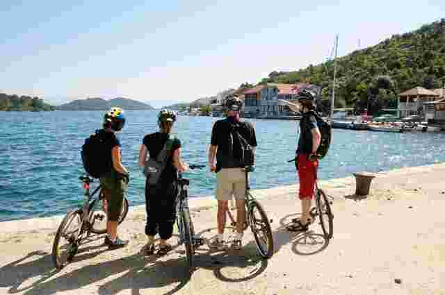 Four cyclists stopping to admire the coast of Mljet in Croatia