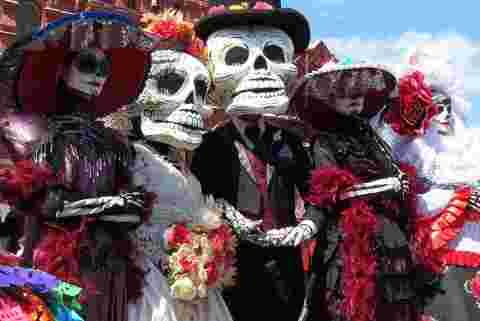 A collection of traditional Day of the Dead costumes used in parades. 