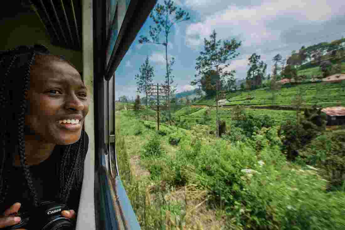 Female traveller looks out of train window in Sri Lanka