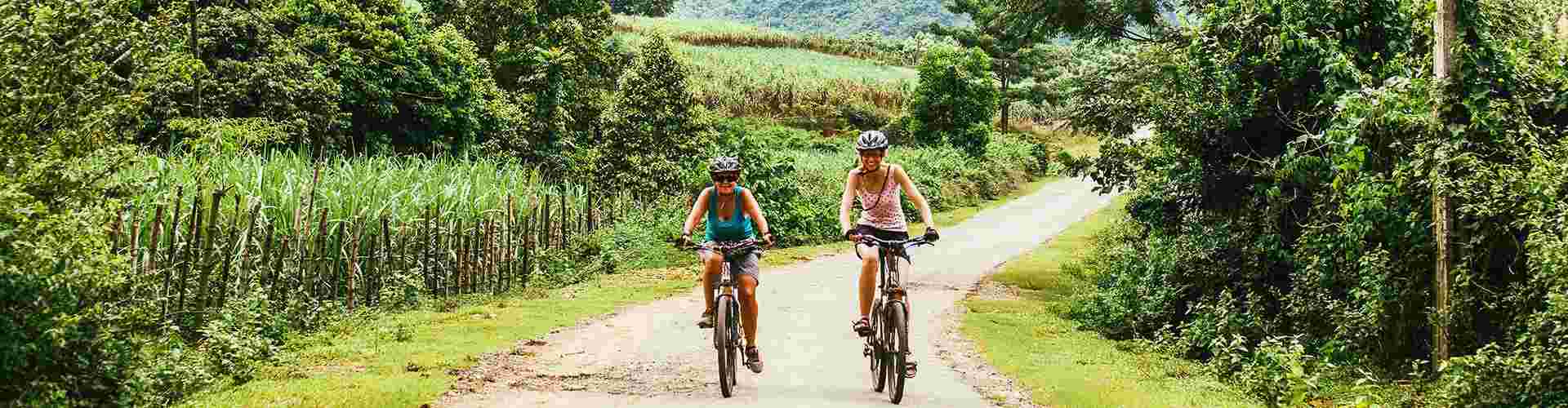 Two travellers cycling through the countryside in Vietnam
