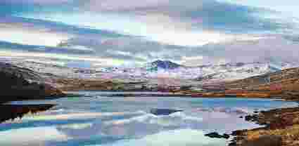 Mountains surrounding lake in Snowdonia, wales