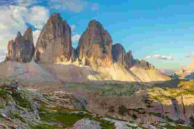 The three tall peaks that make up the Dolomites on a sunny day