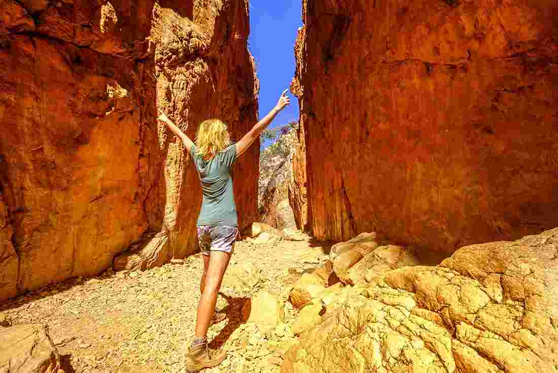 Traveller stands in the Standley Chasm on the Larapinta Trail, Australia