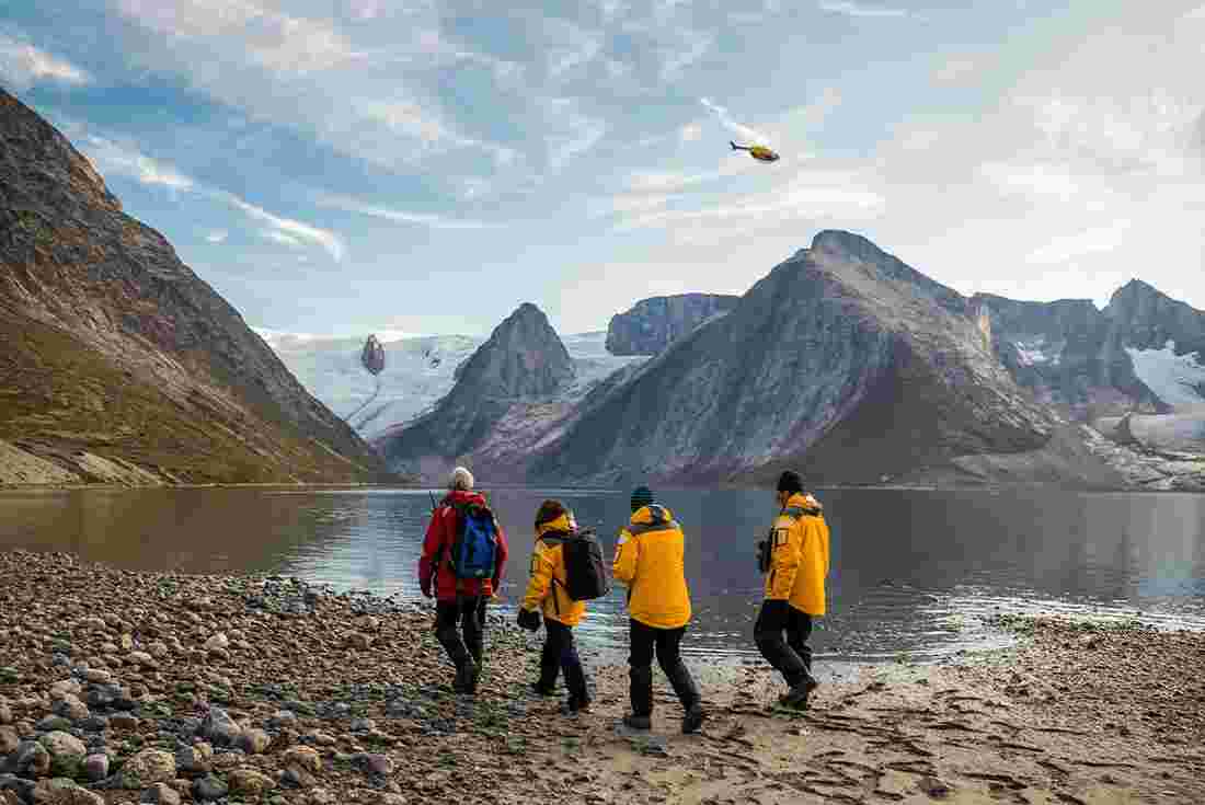 Travellers hiking alongside Tasermiut Fjord, East Greenland