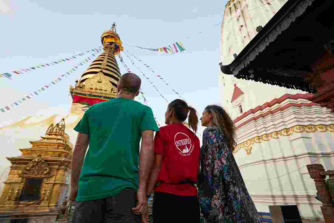 HNPN - Group touring around Kathmandu admiring prayer flags