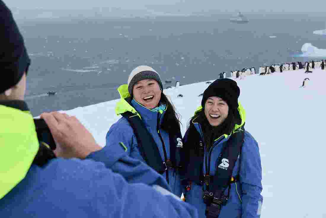 Intrepid Travel Antarctica smiling travellers and penguins