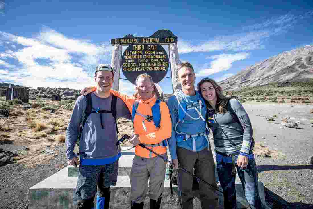 Hikers reach the third cave sign on the Kilimanjaro hike 