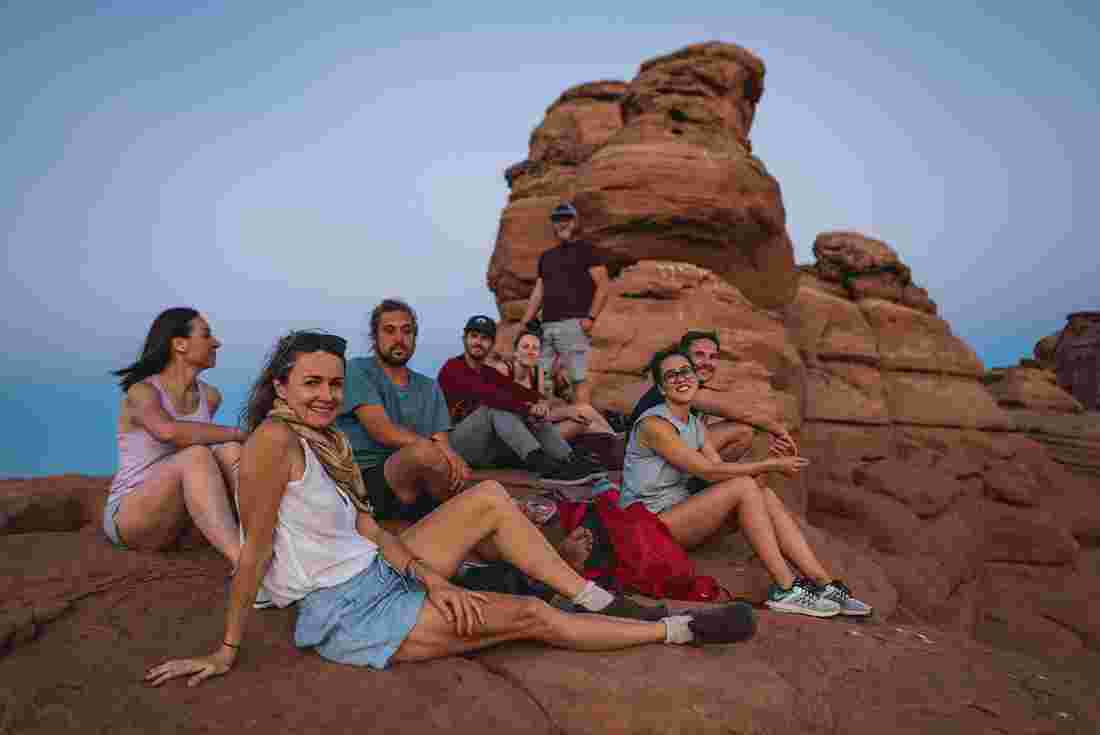 Group of travellers watching the sunset in Arches National Park, Utah, U.S.A.