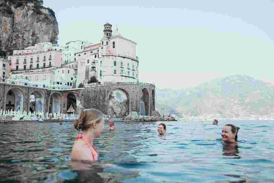 travellers swimming in Italy