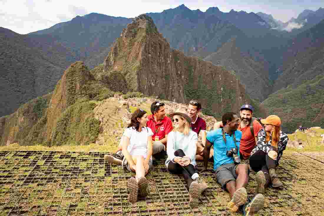 Intrepid group sitting together at Machu Picchu
