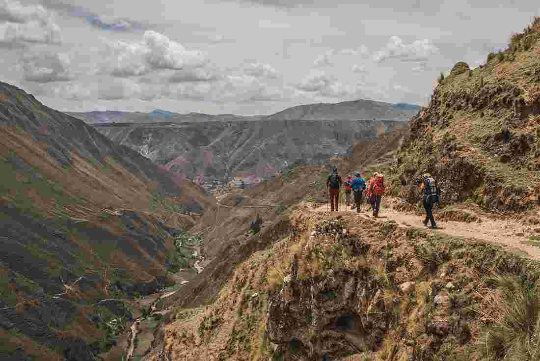 Travellers trekking along a mountain pass on the Great Inca Road