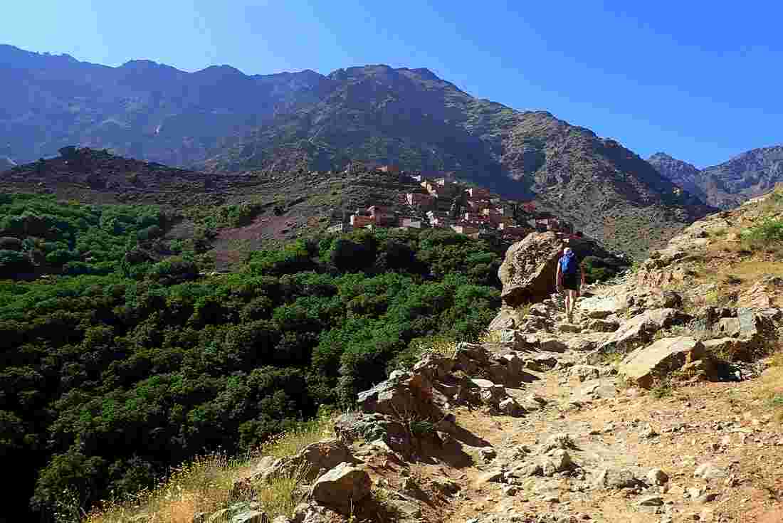 A hiker on trail toward Mount Toubkal in the High Atlas Mountains, Morocco