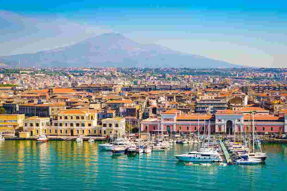 View of the harbour in Catania with Mt Etna in the background, Sicily, Italy