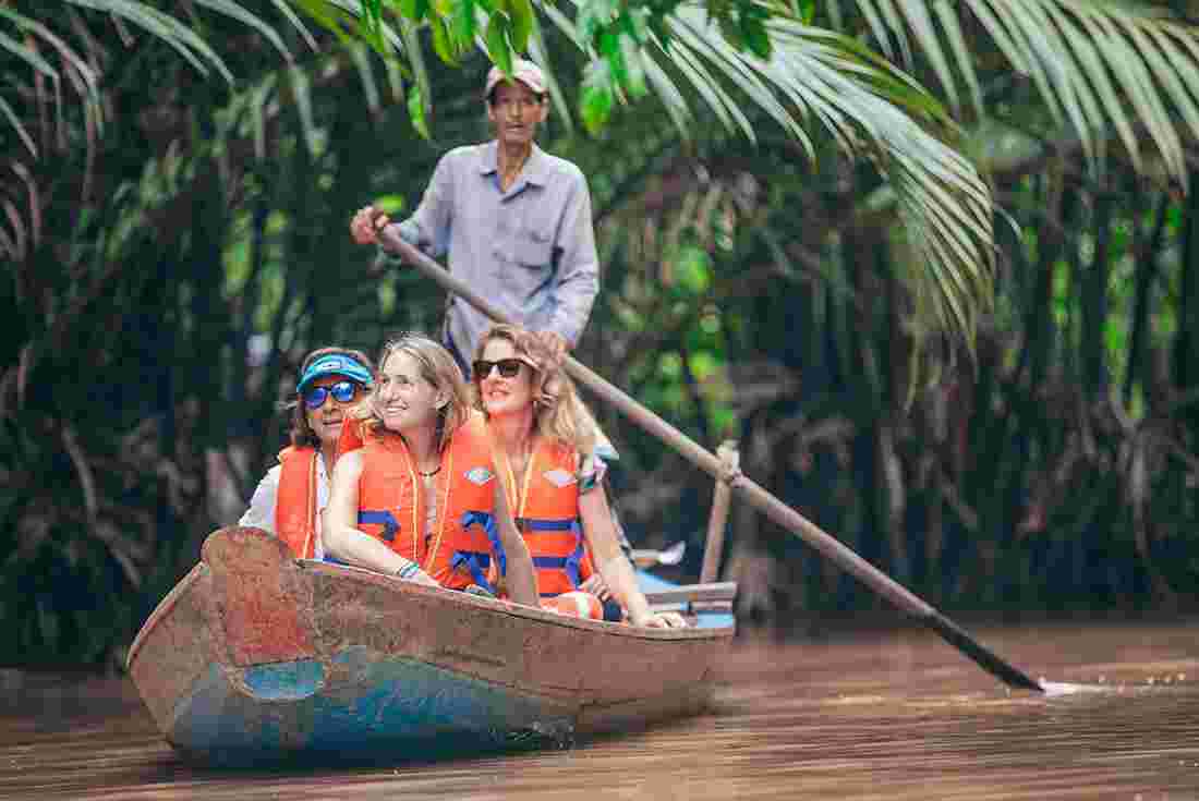 Vietnam insights with Peregrine Adventures: Take a traditional boat through the Mekong Delta