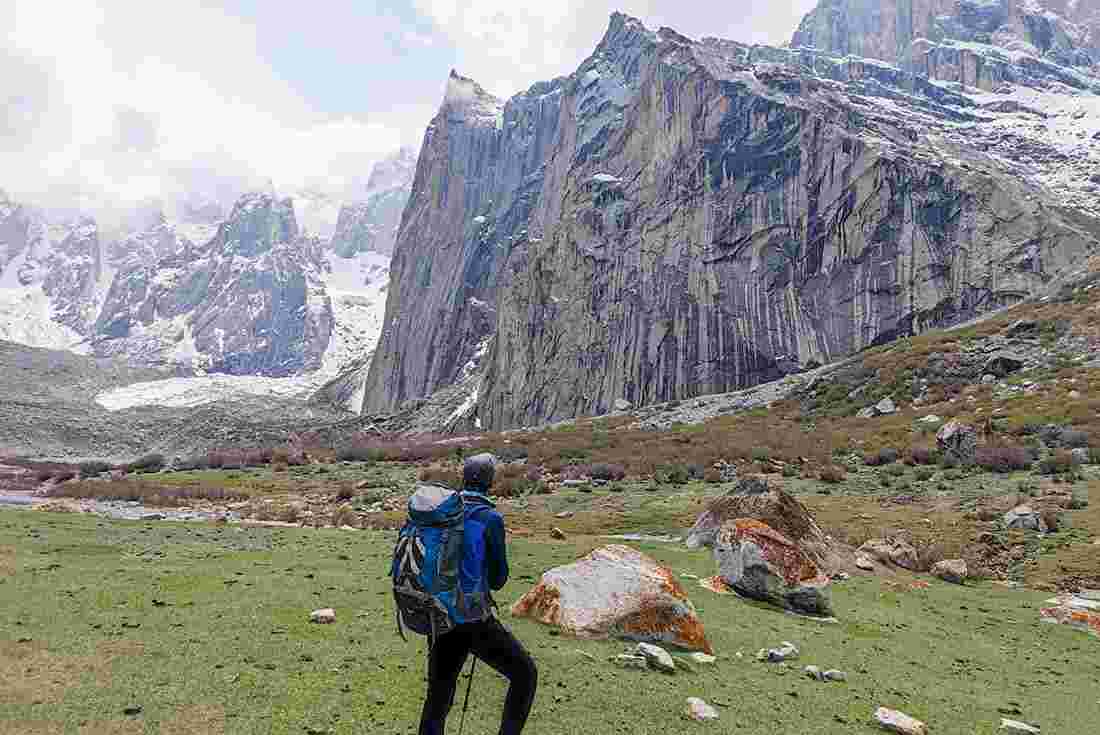 Hiker admiring the mountain peaks of the Nangma Valley, Pakistan