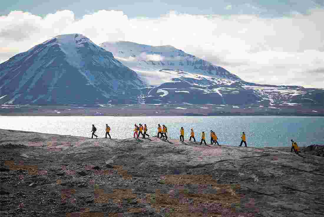 Group of travellers hiking in Svalbard