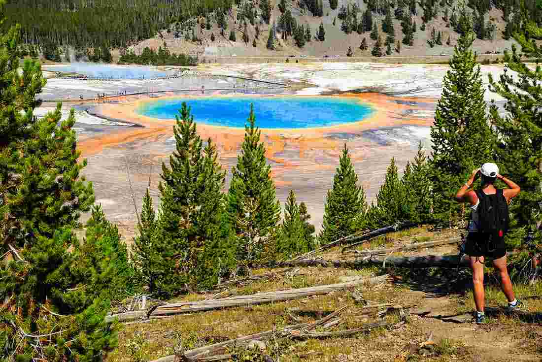 SASY - Person viewing the colourful Grand Prismatic Spring, Yellowstone National Park