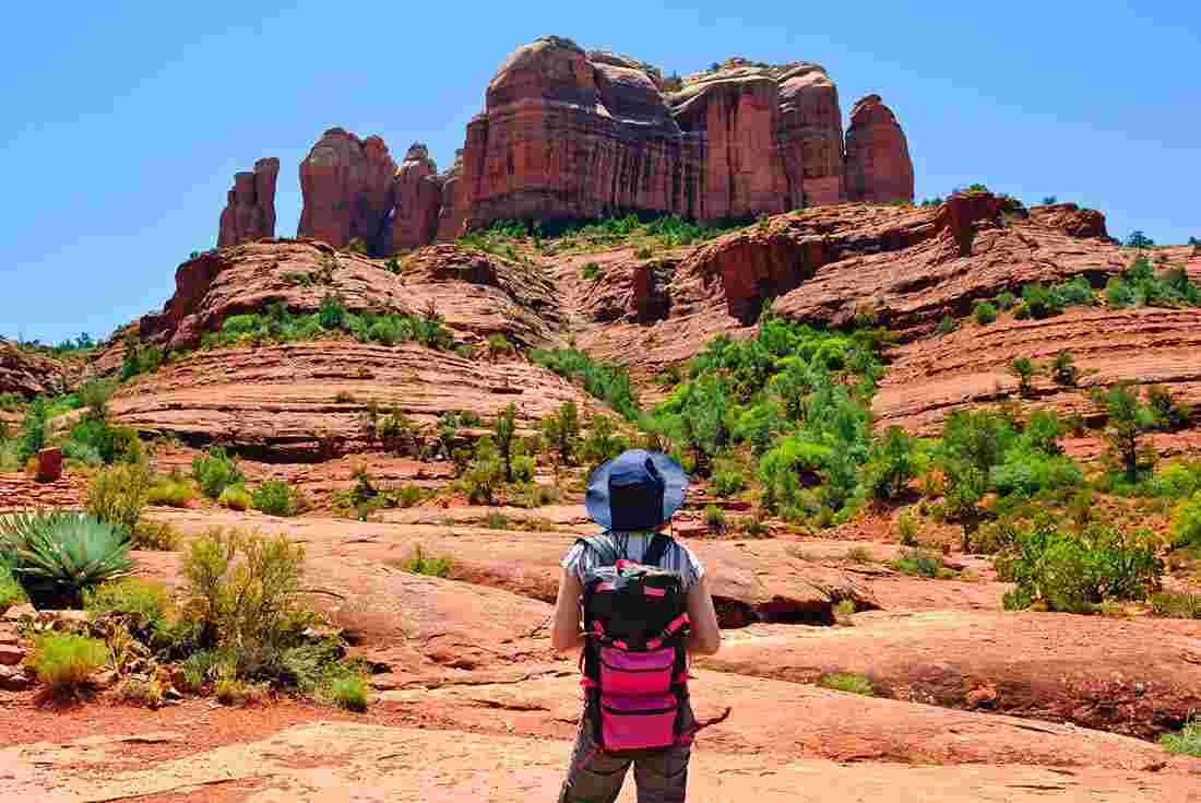 Traveller admiring Cathedral rock on hike in Sedona, Arizona