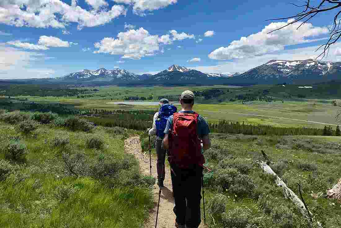 Travellers hiking along trail in Grand Teton National Park, Wyoming, U.S.A.