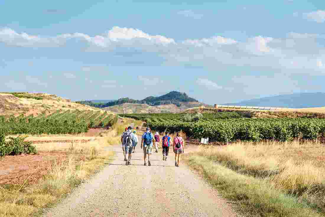 Group hike of pilgrims walking the Camino de Santiago, Spain
