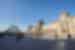 People visit the louvre on a sunny day in Paris