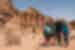 Travellers pose in front of Petra in Jordan with their leader