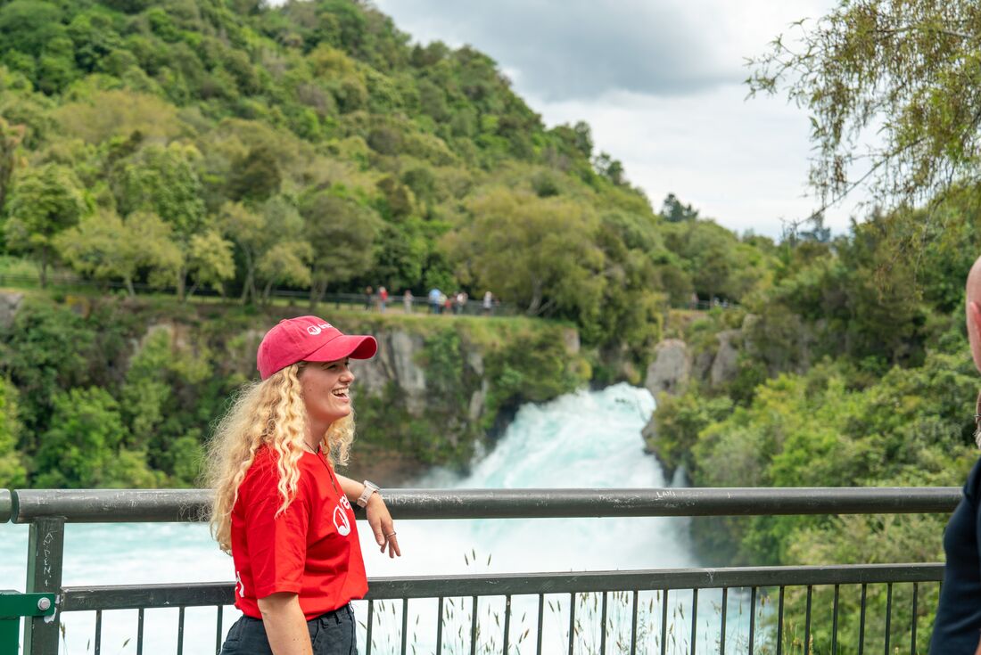 Smiling leader standing at the rails at Huka Falls, New Zealand